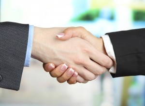 Business handshake on bright background